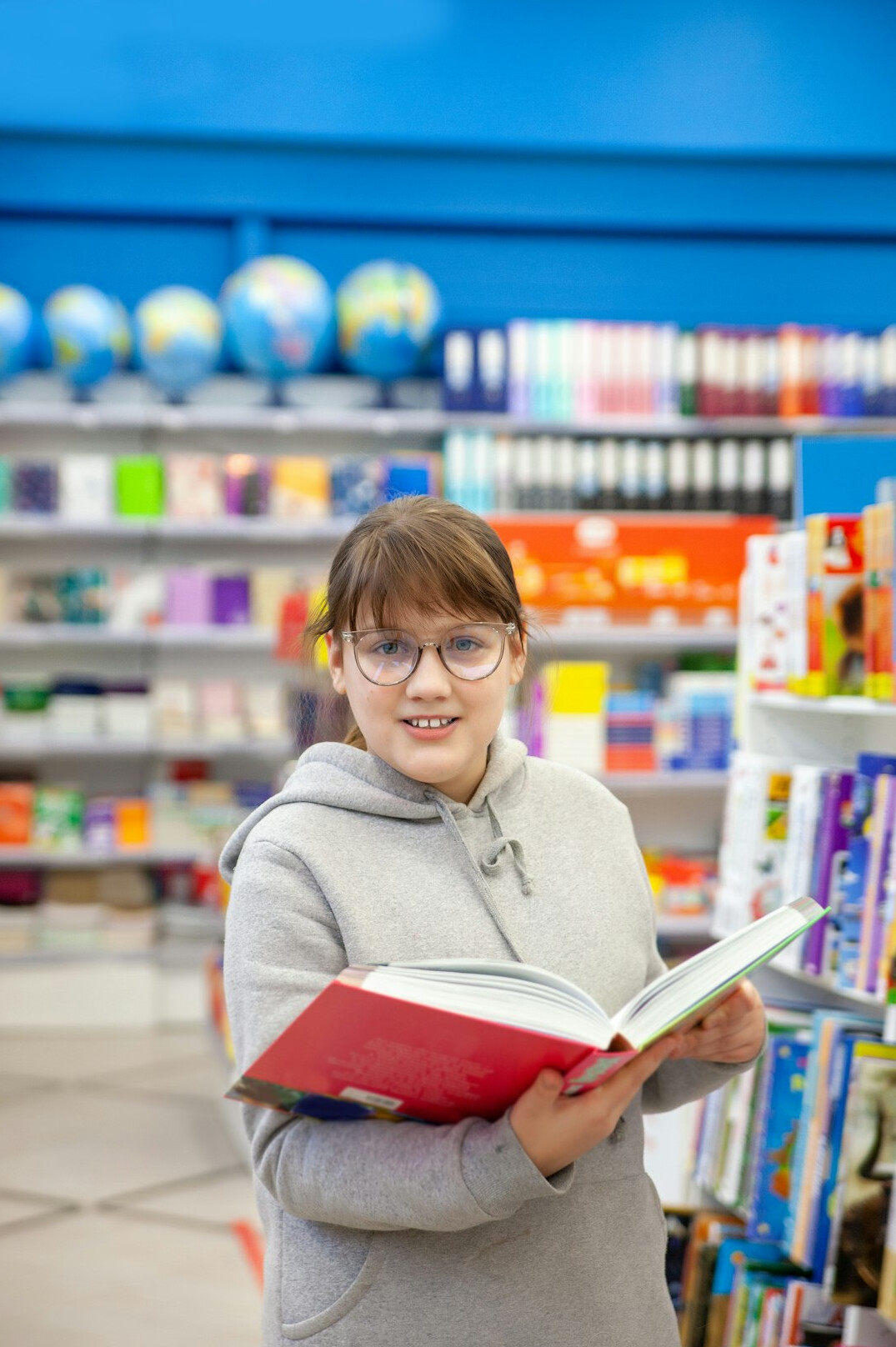 Smiling adult learner woman holding a notebook