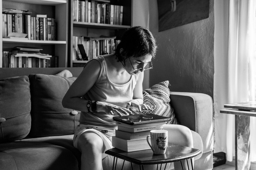 woman reading book at home